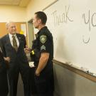 Acting Chancellor Ralph J. Hexter and Acting Provost Ken Burtis speak with Sgt. Max Thomas.