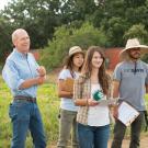 Photo: Smiling Mark Van Horn with three students at the farm.