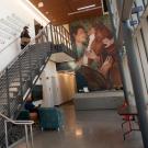 Lobby corridor with two-story-tall horse-and-hands mosaic at the end.