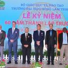 Photo: Ceremonial photo, with group standing in front of colorful banner