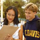 Photo: woman with clipboard with man on her right