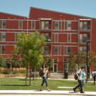 students disembark from a bus at West Village at UC Davis