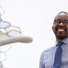 Wilsaan Joiner poses next to DNA sculpture.