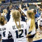 Volleyball players huddle in during a game.