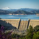 Aerial view of Shasta Dam with mountains in background