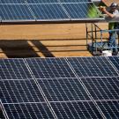 Man installs solar panel over parking lot