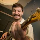 Male student playing a guitar