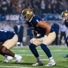 Football players prepare for a play