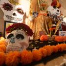 "Ofrenda" commemorating Dia de Los Muertos at Mondavi Center with skeleton mask, orange decorations