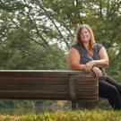 Katy Pattison smiles at a bench on the UC Davis campus. 