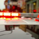 Roof of a police cruiser with red lights on lightbar