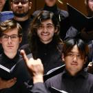 Choir on stage, dressed in black