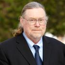 Headshot of male professor in suit 