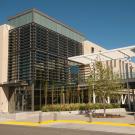 Student walks toward Maurice J. Gallagher Hall at UC Davis