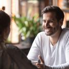 Young woman and man on a speed date sitting at table