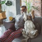 Man sitting on couch with dog