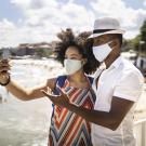 Couple taking selfie on beach sidewalk