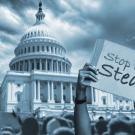 Black-and-white photo of U.S. capitol with protest signs and protestors in foreground