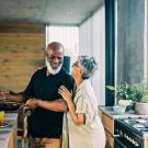 Couple cooking in kitchen smiling