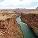 Aerial of Colorado River running through sandtone canyon 