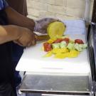 Street vendor cutting food. 