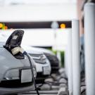 Electric vehicles charge in a parking garage