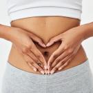 A person forming a heart shape with their hands over their abdomen. An international panel led by UC Davis professor Maria Marco defines “gut health” for the first time, offering a scientific framework for medicine, research and consumer claims. (Getty)