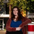 Kaitlin "Kat" Raymond stands in front of Hawthorn Hall