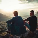 Two men looking at sunset.