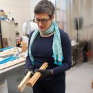 Woman holds rectangular materials in a lab