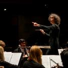 Symphony being directed by a woman on stage 