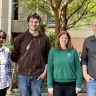 Group of four people facing camera, outdoors