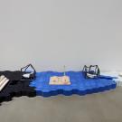 Installation view of art depicting tools to weigh and measure at Manetti Shrem Museum 