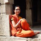 Archana Venkatesan amid ruins, with book cover