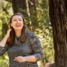 Janaé Bonnell walks among the UC Davis Arboretum redwood trees