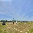 Blue sky in background of campus weather station with post, dials, and other equipment.