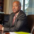 Chancellor Gary S. May sits at desk.