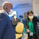 Chancellor Gary S. May, in face mask, observes as Uma N. Srivatsa shows a model of the heart