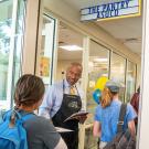 Chancellor Gary S. May greets students walking into the Pantry