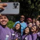 Chancellor Gary S. May poses for selfie with students during Picnic Day.