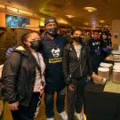 Chancellor Gary S. May poses for photo with students at Moonlight Breakfast