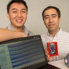 A student and professor pose next to their computer engineering project