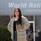 Female student stands in front of World Relief offices