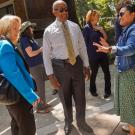 Mary Croughan and Gary S. May speak to a staffer on Wyatt Deck.