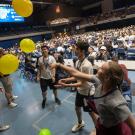 New students play with balloons at mass orientation event