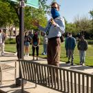 Teacher and students in face coverings, on walking tour, outdoors.