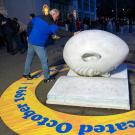 Kirk Arneson touches Bookhead sculpture