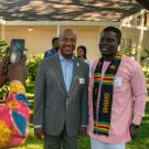 Chancellor Gary S. May poses for a photo with Mandela Fellows in 2019.