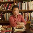 Chef Martin Yan sits among cookbooks donated to UC Davis