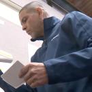 Man looks through stack of index cards.